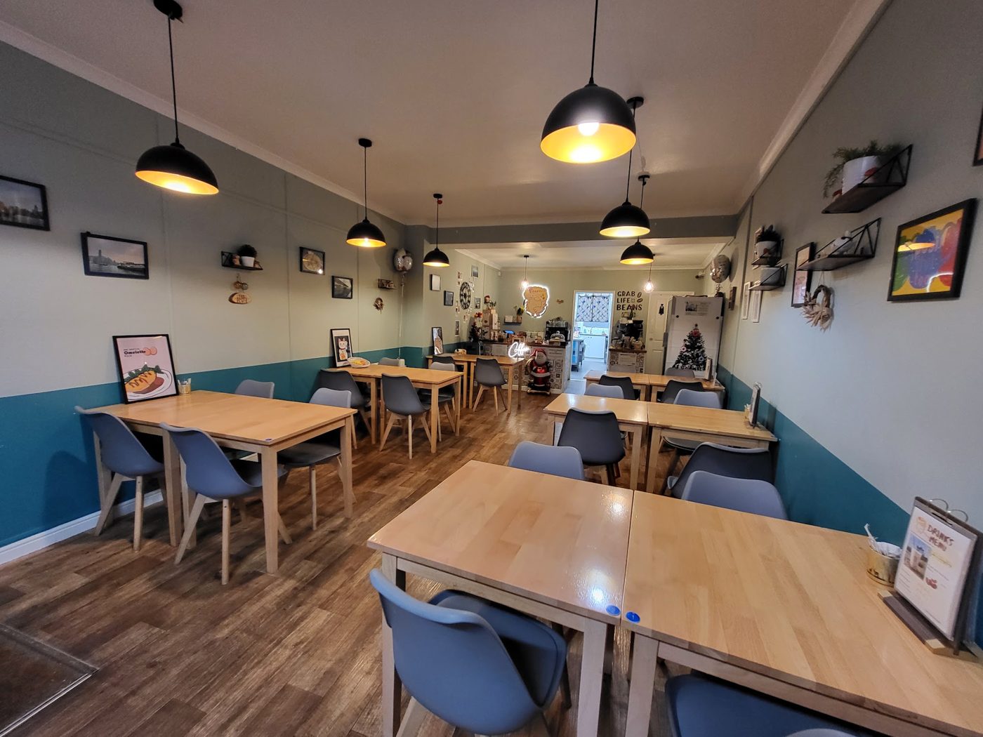 The dining room with wooden tables and pendant lamps