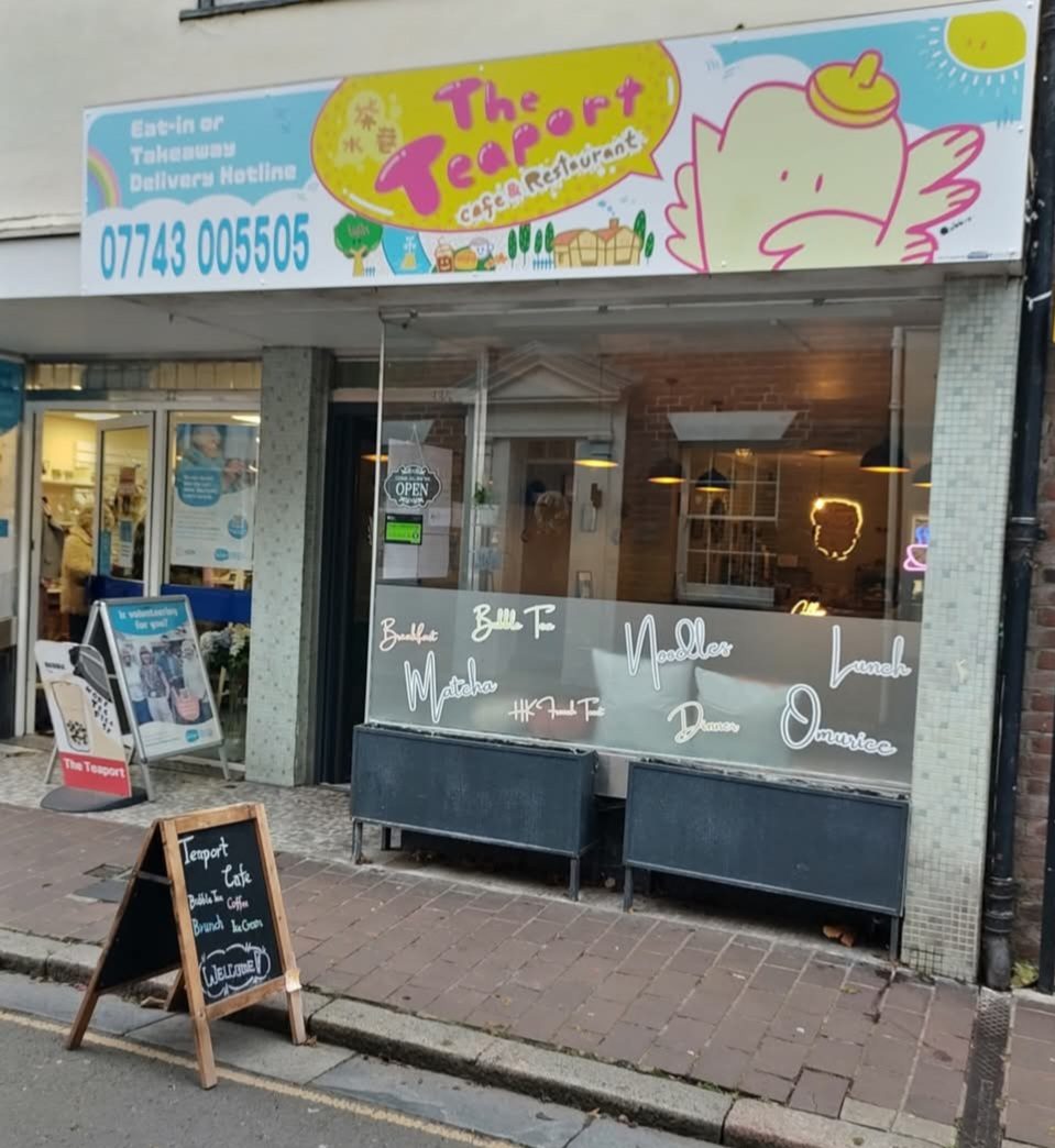 The shopfront with the colourful THE TEAPORT sign and a chalkboard outside